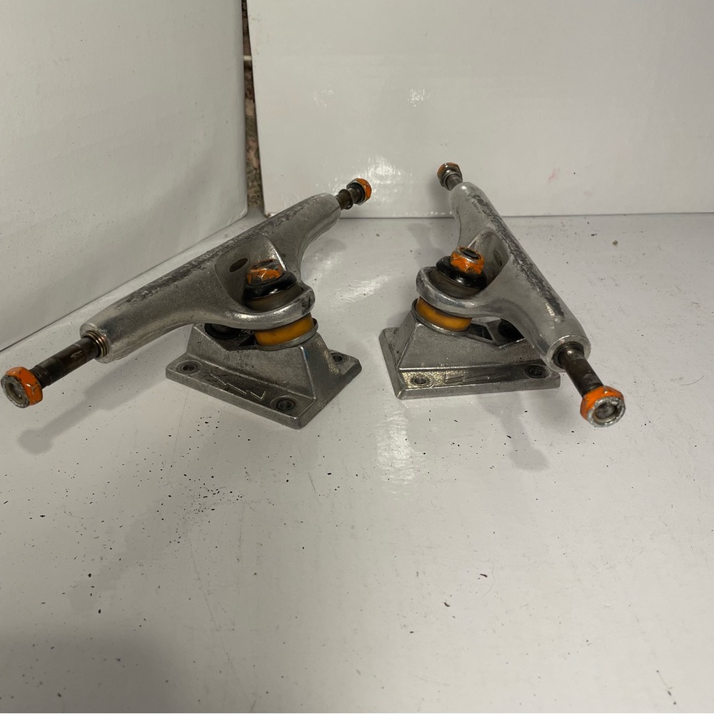 Thunder Silver Skateboard Trucks with Orange Accents-lightly used.